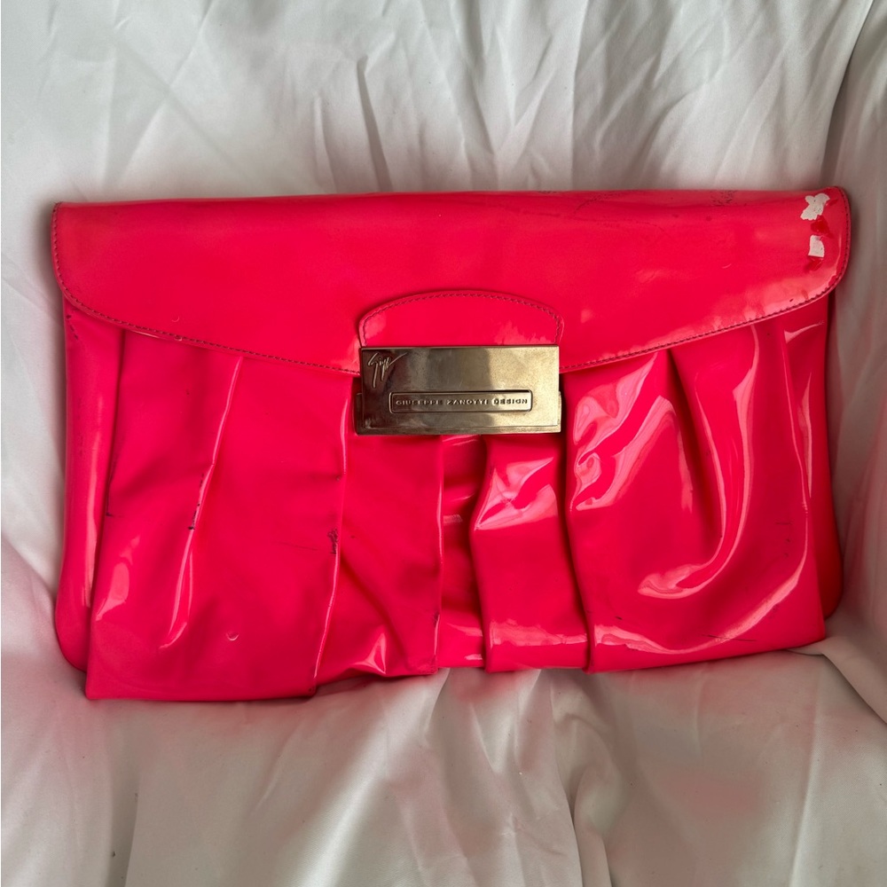 Neon pink oversized Giuseppe Zanotti clutch.